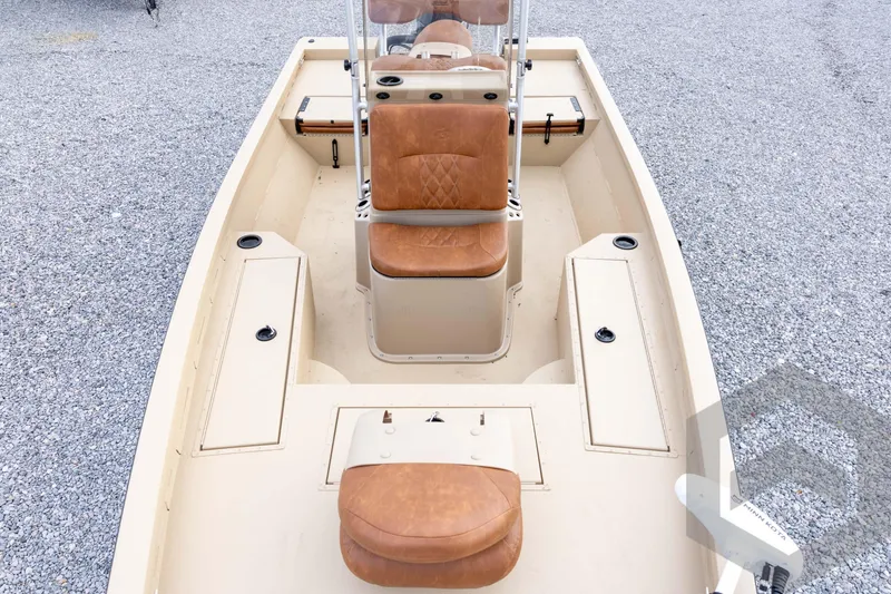 Slide: The Image of 2026 G3 Bay 19 GX boat interior with tan seating and storage compartments. - 20