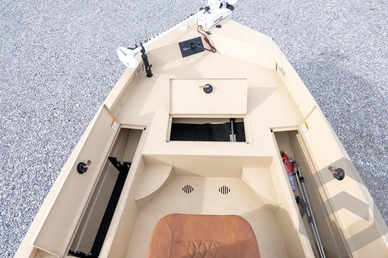Slide: The Image of 2026 G3 Bay 19 GX boat interior with storage compartments and equipment on gravel surface. - 18