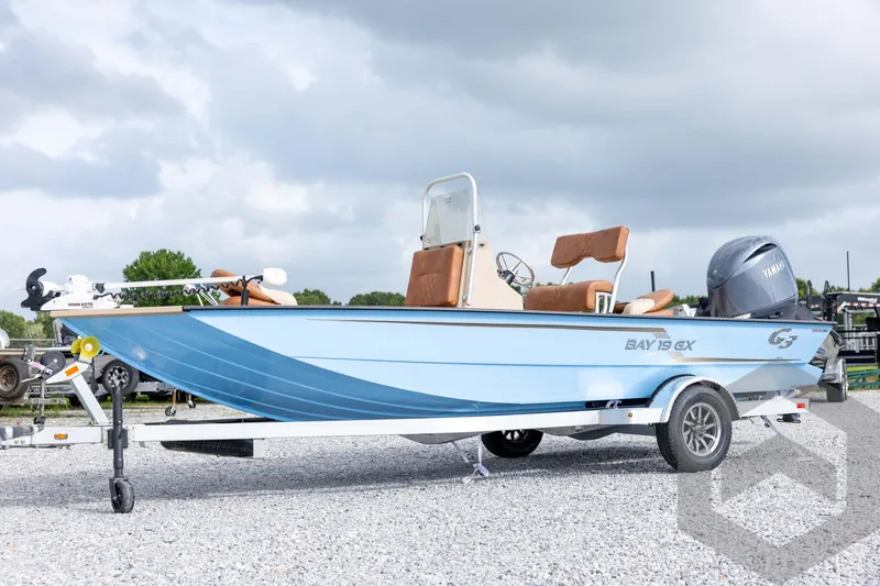 Slide: The Image of 2026 G3 Bay 19 GX boat on trailer, featuring Yamaha motor, under cloudy sky. - 43