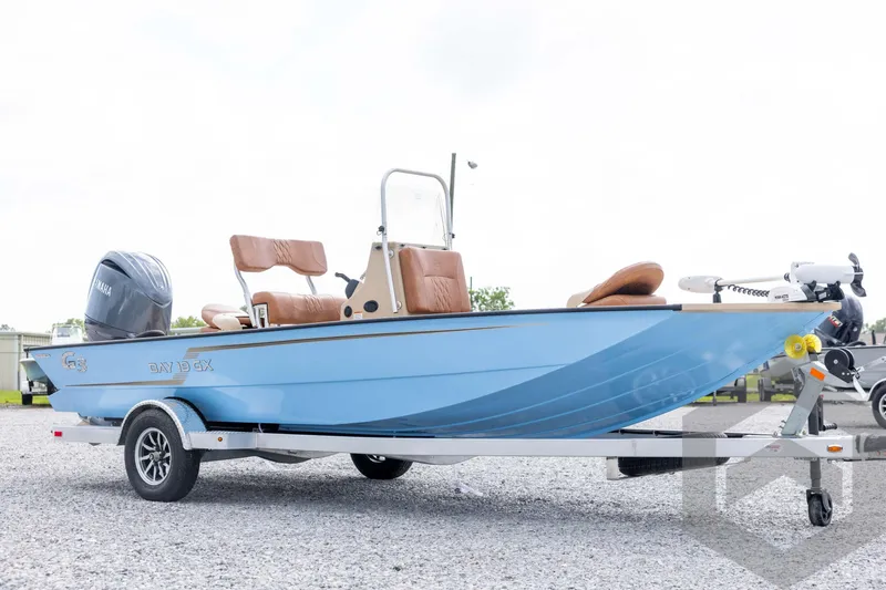 Slide: The Image of 2026 G3 Bay 19 GX boat on trailer, featuring blue hull and Yamaha outboard motor. - 2