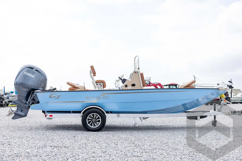 Slide: The Image of 2026 G3 Bay 19 GX boat with Yamaha motor on gravel lot. - 3