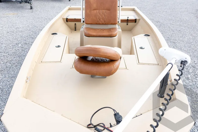 Slide: The Image of 2026 G3 Bay 19 GX boat interior with tan seating and storage compartments. - 14
