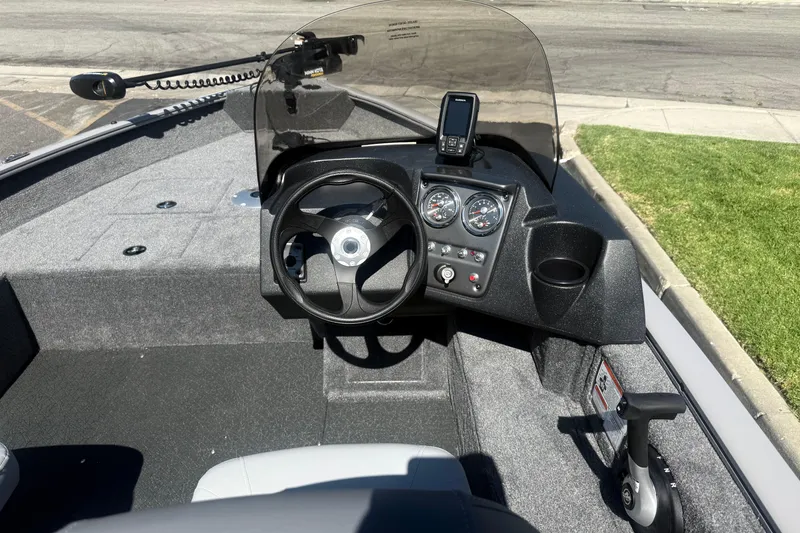 Slide: The Image of 2027 Tracker Pro Guide V-16 SC boat dashboard with steering wheel and gauges. - 18