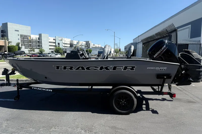 Slide: The Image of 2027 Tracker Pro Guide V-16 SC boat on trailer, parked outdoors. - 2
