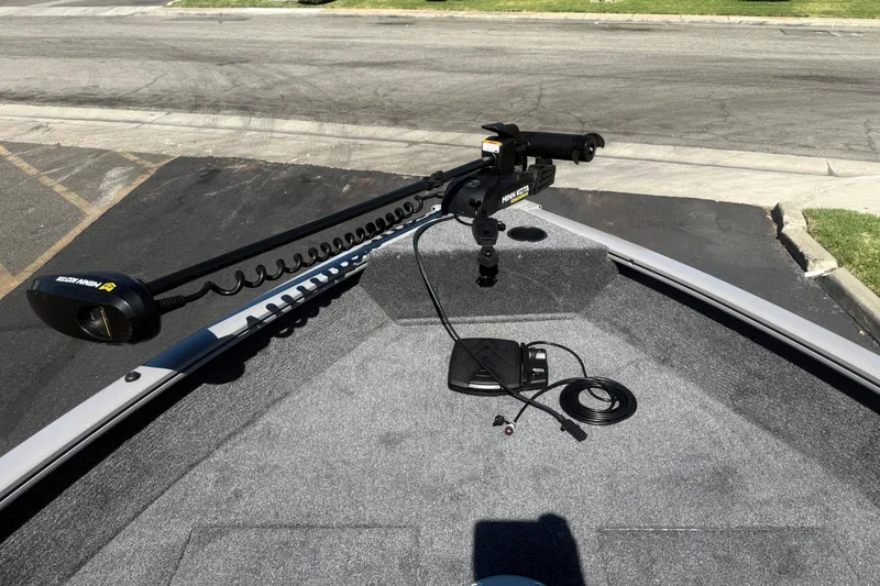 Slide: The Image of 2027 Tracker Pro Guide V-16 SC boat with Minn Kota trolling motor on deck. - 13