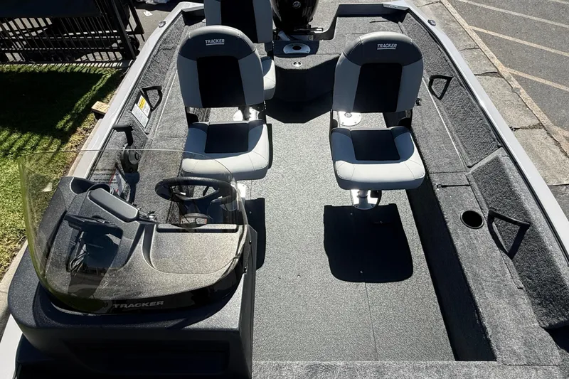 Slide: The Image of 2027 Tracker Pro Guide V-16 SC boat interior with dual seats and steering console. - 10