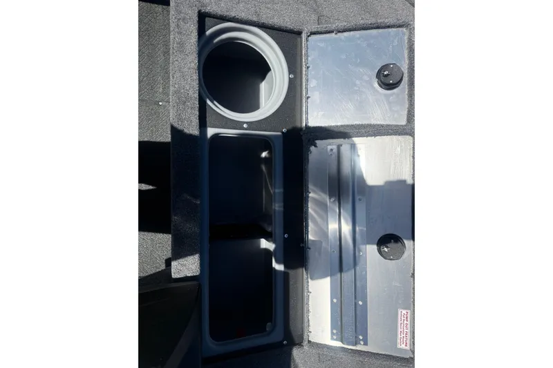 Slide: The Image of 2027 Tracker Pro Guide V-16 SC boat storage compartments with circular and rectangular openings. - 11