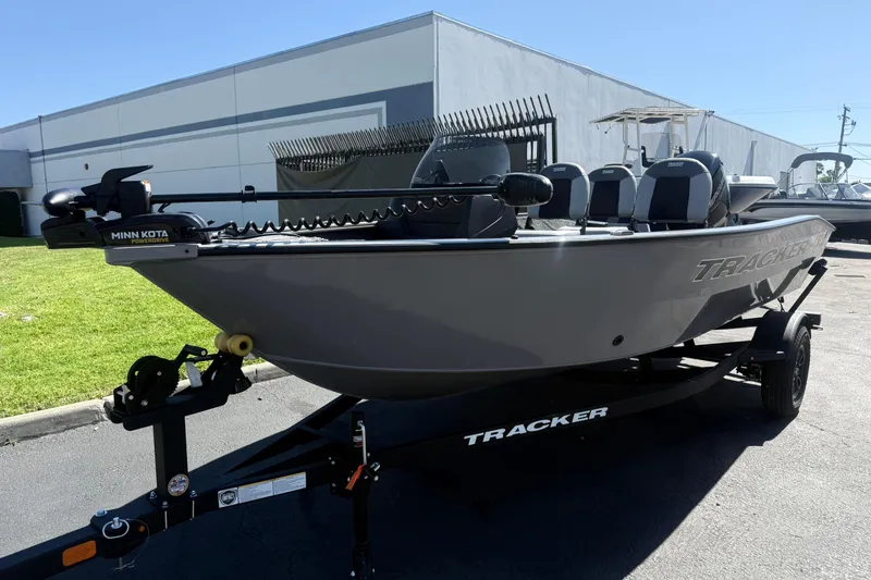 Slide: The Image of 2027 Tracker Pro Guide V-16 SC boat on trailer, parked outdoors. - 5