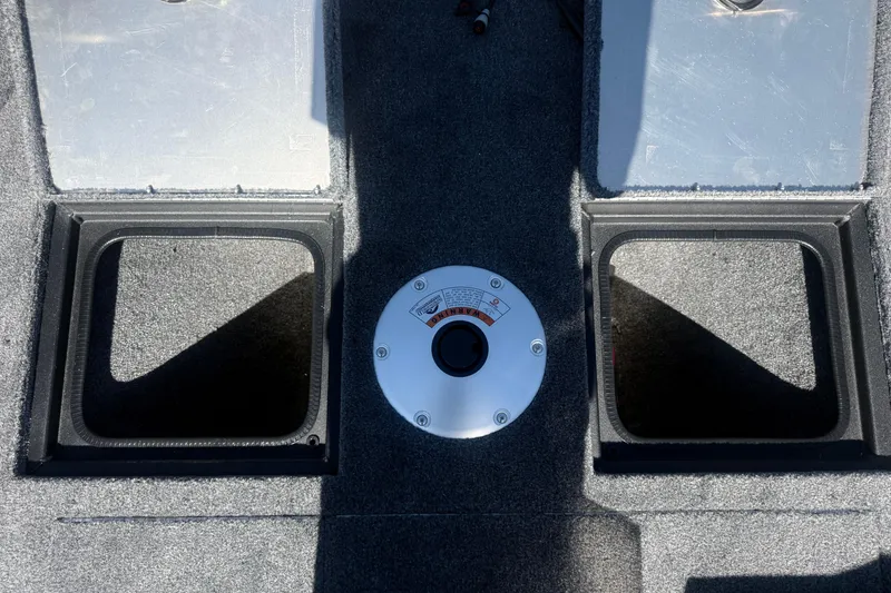 Slide: The Image of 2027 Tracker Pro Guide V-16 SC boat interior with storage compartments and a central gauge. - 12