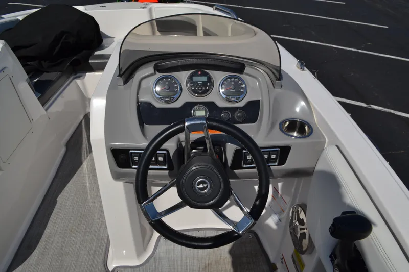 Slide: The Image of 2018 Chaparral 191 Suncoast boat dashboard with steering wheel and gauges. - 9