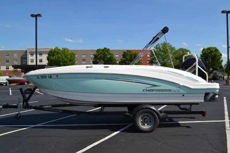 The Image of 2018 Chaparral 191 Suncoast boat on trailer in parking lot, clear sky background. - 0