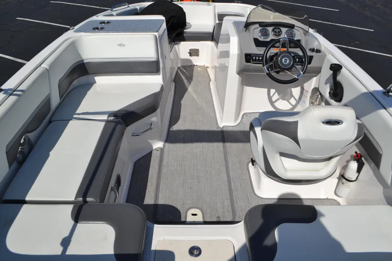 Slide: The Image of 2018 Chaparral 191 Suncoast boat interior with seating, steering wheel, and dashboard. - 6