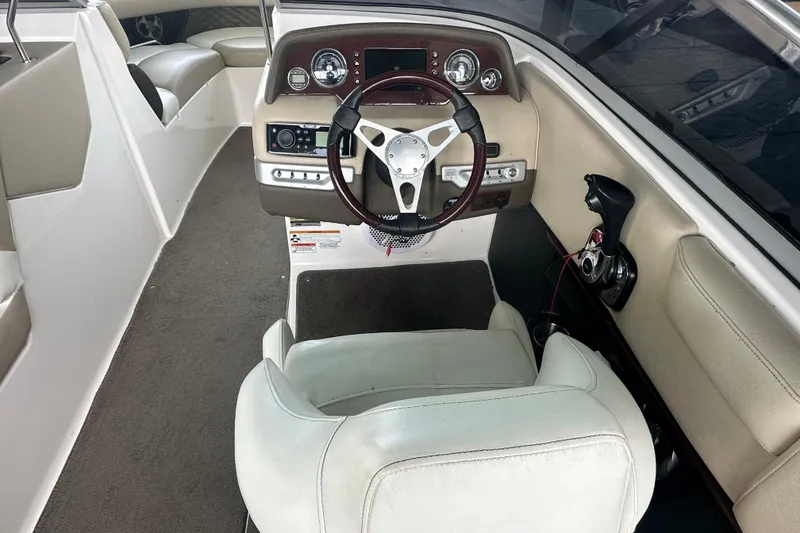 Slide: The Image of Interior of a 2012 Regal 2300 RX Bowrider boat, featuring steering wheel and dashboard controls. - 4