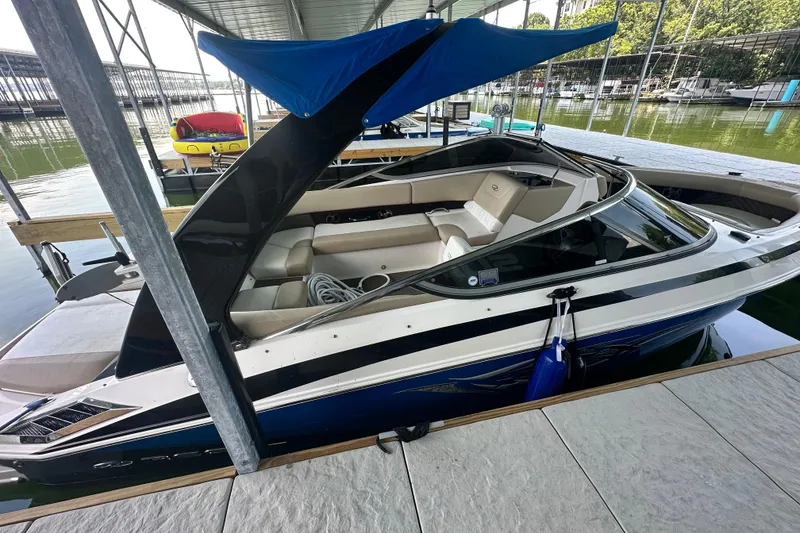 Slide: The Image of 2012 Regal 2300 RX Bowrider docked, featuring sleek design and spacious seating. - 3