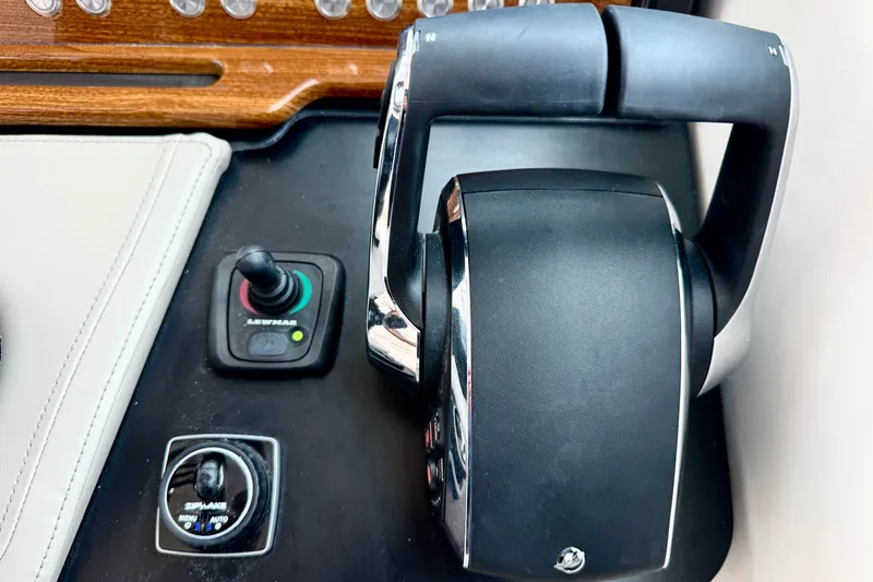 Slide: The Image of Control panel of 2027 Tiara Yachts 34 LX, featuring joystick and throttle controls. - 30