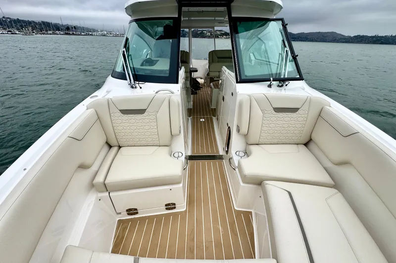 Slide: The Image of Luxurious 2027 Tiara Yachts 34 LX boat interior with elegant seating and scenic water view. - 36