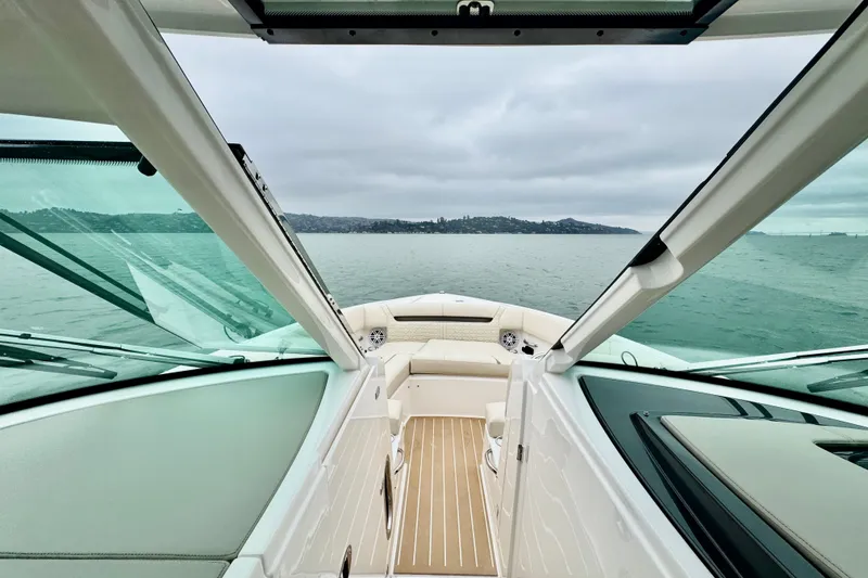 Slide: The Image of 2027 Tiara Yachts 34 LX interior view, showcasing luxurious seating and expansive ocean backdrop. - 32