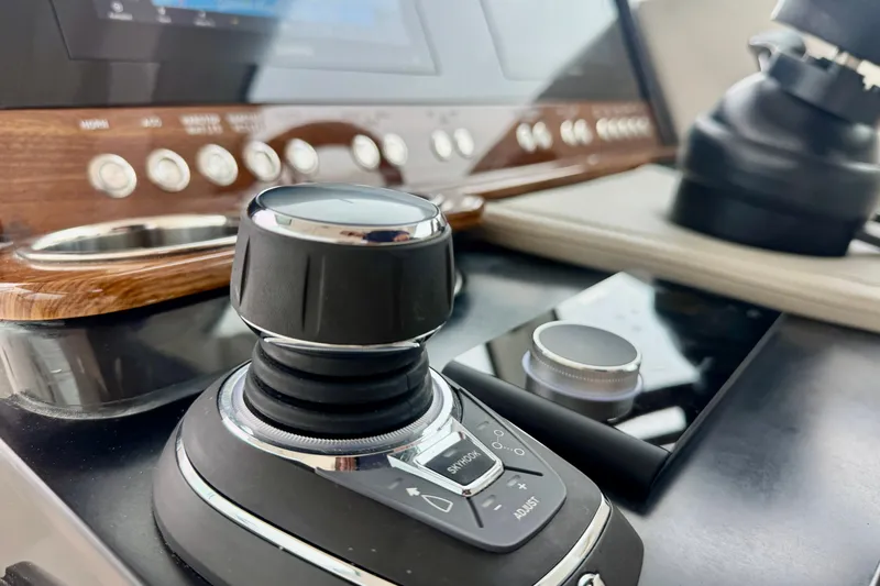 Slide: The Image of 2027 Tiara Yachts 34 LX control panel with joystick and navigation controls. - 28