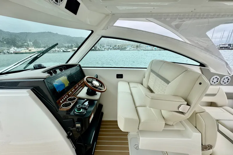 Slide: The Image of Luxurious interior of 2027 Tiara Yachts 34 LX, featuring modern helm and plush seating. - 23