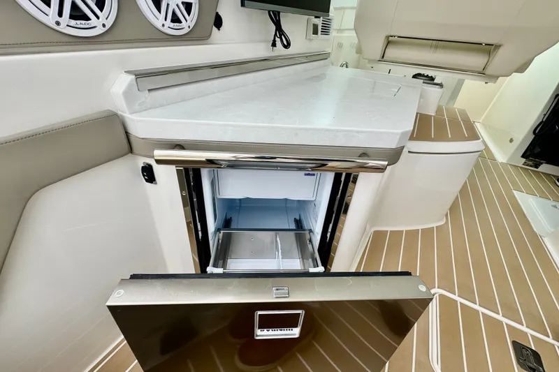 Slide: The Image of 2027 Tiara Yachts 34 LX interior with open refrigerator and modern design elements. - 16