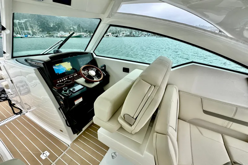 Slide: The Image of 2027 Tiara Yachts 34 LX helm with modern navigation system and luxurious seating. - 21