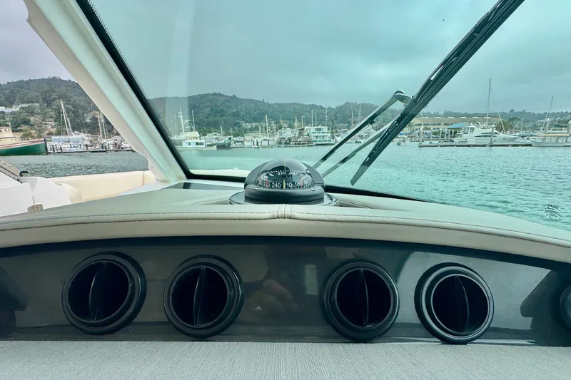 Slide: The Image of Interior view of 2027 Tiara Yachts 34 LX, featuring dashboard and compass. - 31