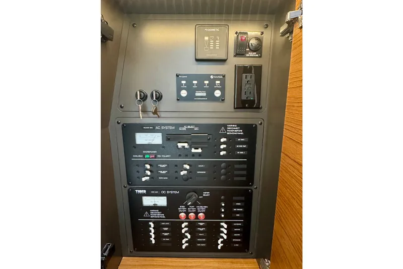 Slide: The Image of Electrical control panel of 2027 Tiara Yachts 34 LX, featuring AC and DC systems. - 41