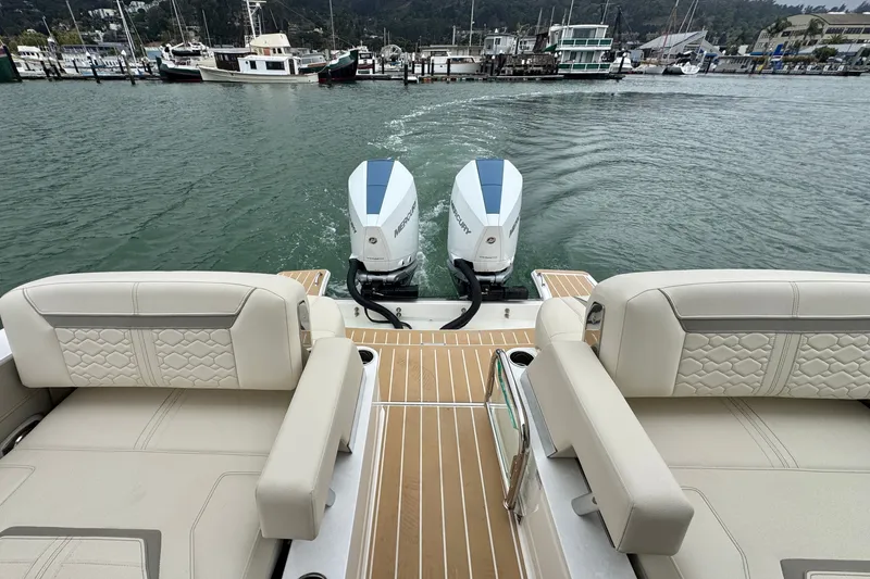 Slide: The Image of 2027 Tiara Yachts 34 LX with dual Mercury outboard engines, docked in a marina. - 17
