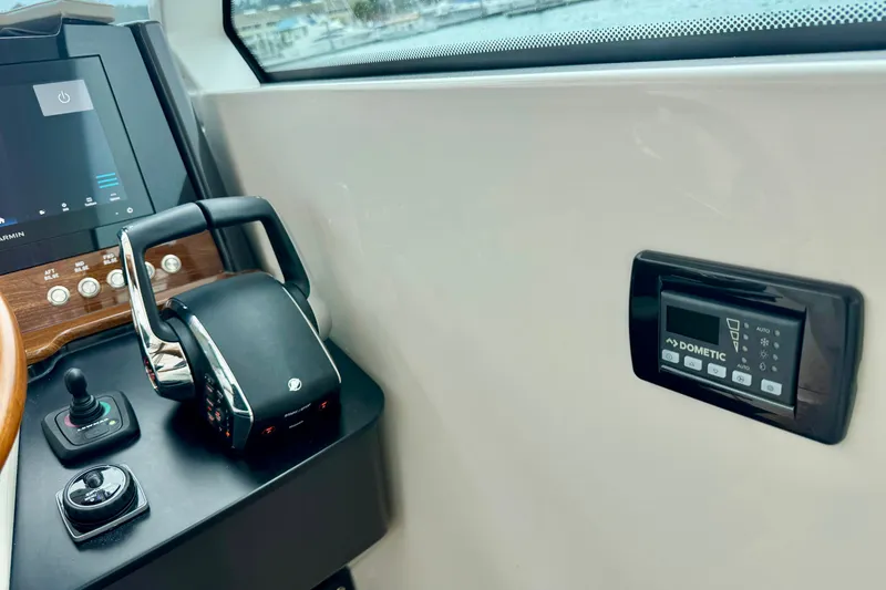 Slide: The Image of Control panel and throttle of 2027 Tiara Yachts 34 LX, featuring advanced navigation technology. - 29