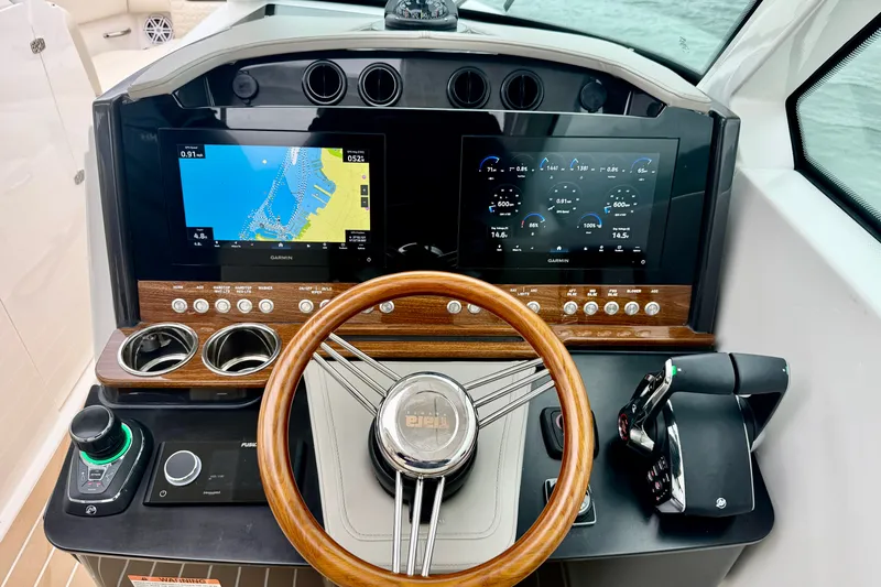 Slide: The Image of Helm of 2027 Tiara Yachts 34 LX with advanced navigation displays and controls. - 24