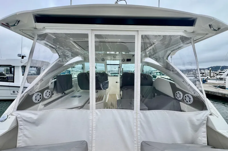 Slide: The Image of 2027 Tiara Yachts 34 LX interior view, featuring sleek design and modern amenities at the marina. - 13