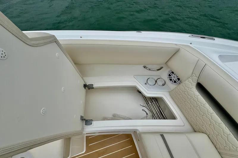 Slide: The Image of 2027 Tiara Yachts 34 LX interior with open storage compartment and luxurious seating. - 34