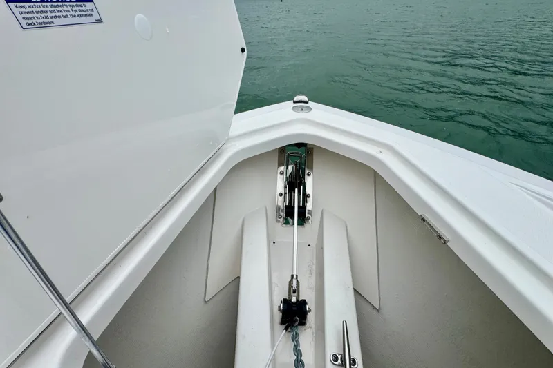 Slide: The Image of Bow anchor compartment of 2027 Tiara Yachts 34 LX on calm water. - 35