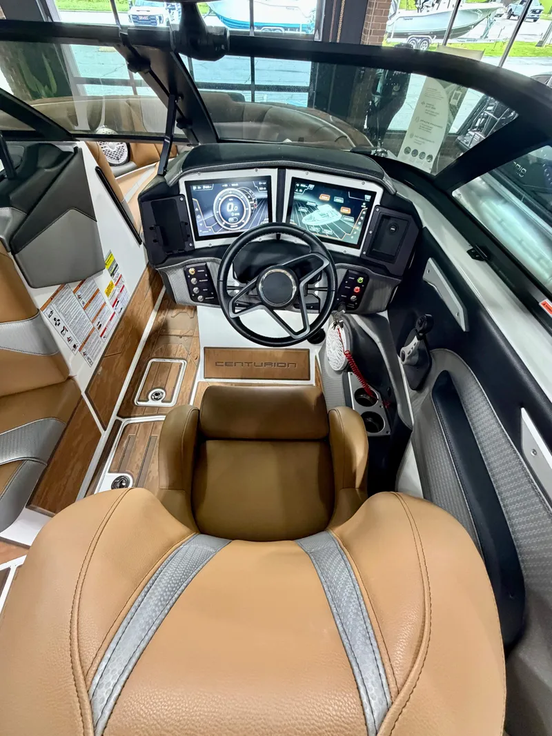 Slide: The Image of The image shows the cockpit of a 2022 Centurion Ri245 boat with modern instruments and leather seating. - 12