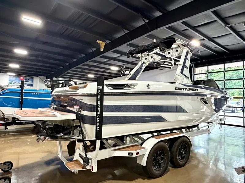 Slide: The Image of A 2022 Centurion Ri245 on a trailer in a showroom. The boat features a sleek design. - 5