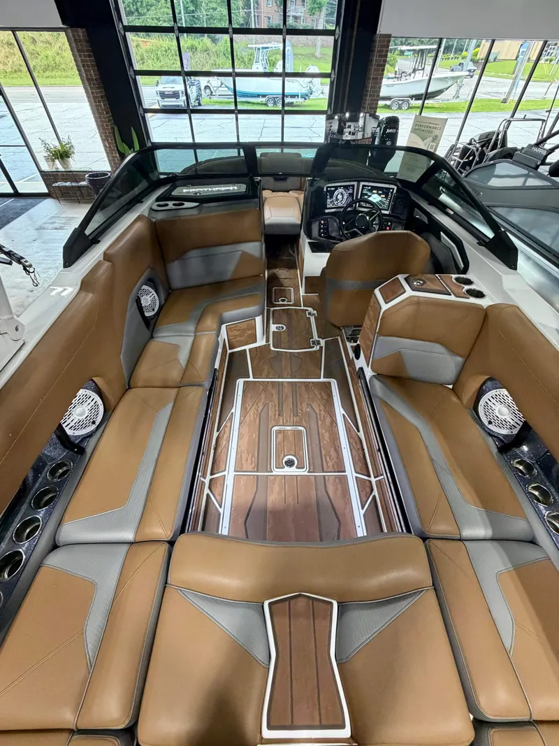 Slide: The Image of Interior of a 2022 Centurion Ri245 with luxurious brown and gray seating and wood flooring. - 9