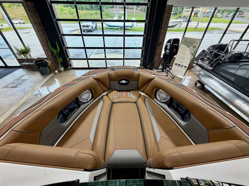Slide: The Image of The image shows the interior of a 2022 Centurion Ri245 boat with brown leather seating. - 17