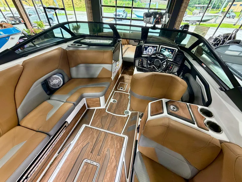 Slide: The Image of The image shows the luxurious interior of a 2022 Centurion Ri245 boat with brown leather seating. - 11