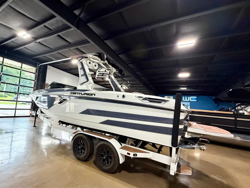 Slide: The Image of A 2022 Centurion Ri245 boat is on a trailer in a showroom. - 3
