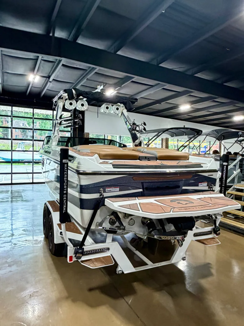 Slide: The Image of A 2022 Centurion Ri245 boat is in a showroom. It features a modern design and platform. - 4