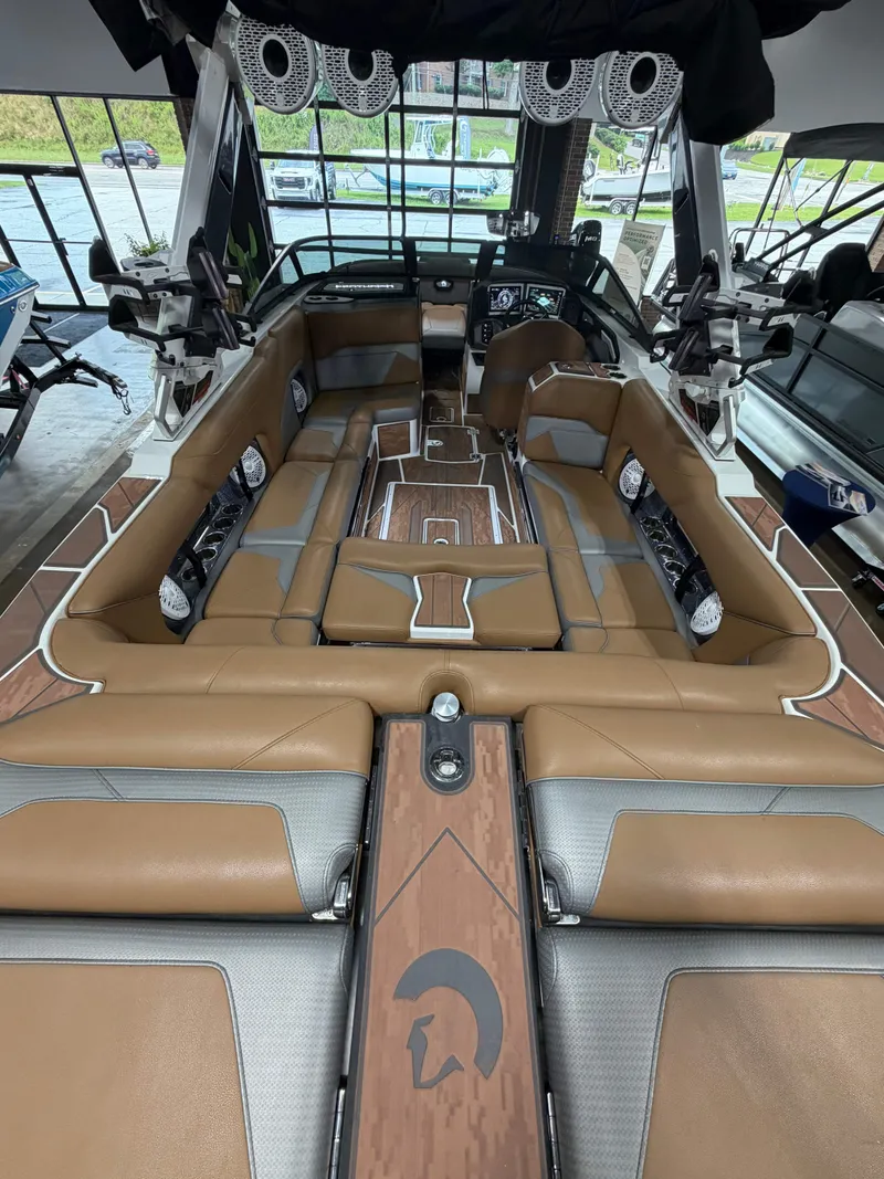 Slide: The Image of The image shows the luxurious interior of a 2022 Centurion Ri245 boat with brown leather seating. - 8