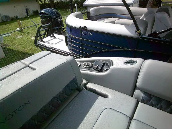 Slide: The Image of The image shows the interior of a 2024 Bennington 23RSB Swingback Tritoon with luxurious seating. - 2