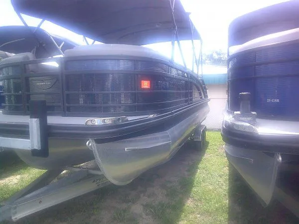 Slide: The Image of A 2024 Bennington 23RSB Swingback Tritoon on a trailer, featuring sleek design and sturdy hull. - 13