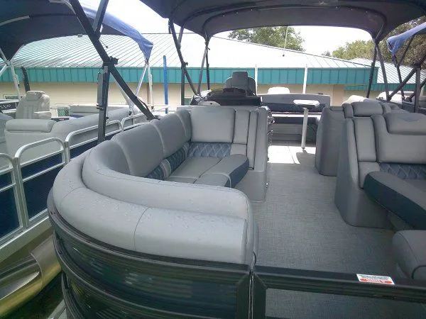 Slide: The Image of The image shows the spacious deck of a 2024 Bennington 23RSB Swingback Tritoon with gray upholstery. - 8
