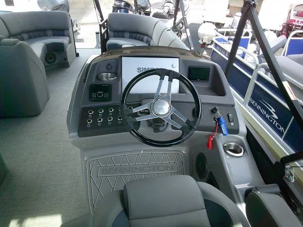 Slide: The Image of The image shows the cockpit of a 2024 Bennington 23RSB Swingback Tritoon with a modern helm. - 5