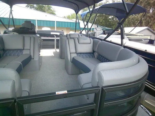 Slide: The Image of The image shows the interior of a 2024 Bennington 23RSB Swingback Tritoon with gray upholstered seating. - 9