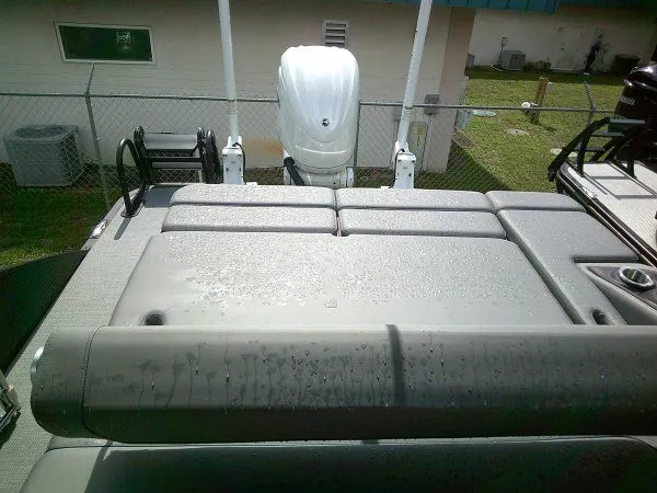 Slide: The Image of The image shows the rear of a Bennington 23RSB Swingback Tritoon with an outboard motor. - 4