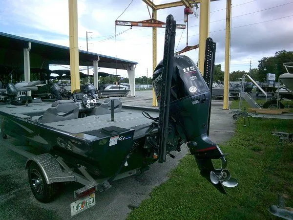 Slide: The Image of A 2022 G3 Sportsman 1810 boat with a 115 HP outboard motor, parked on a trailer. - 5