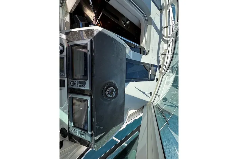 Slide: The Image of Close-up of the helm station on a 2010 Sea Ray 470 Sundancer with instruments and controls. - 20