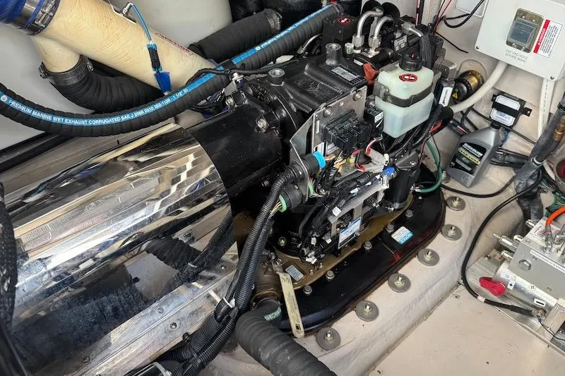 Slide: The Image of Engine compartment of a 2010 Sea Ray 470 Sundancer, showcasing mechanical components and wiring. - 8